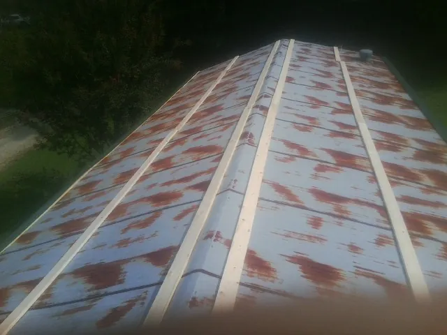 Rusted metal roof panels with new wood purlins before replacement — Storm Damage Roof Repair in Bushwood by Roofing Brothers